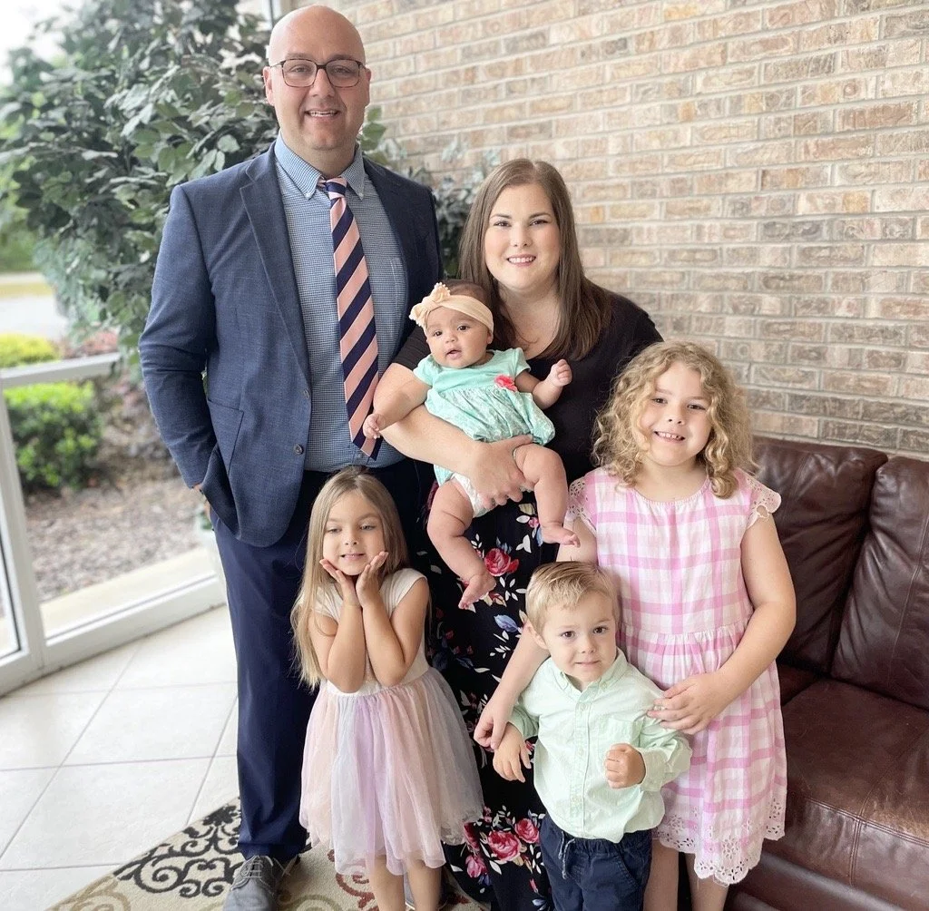 Eric May with his wife Jenna and their children